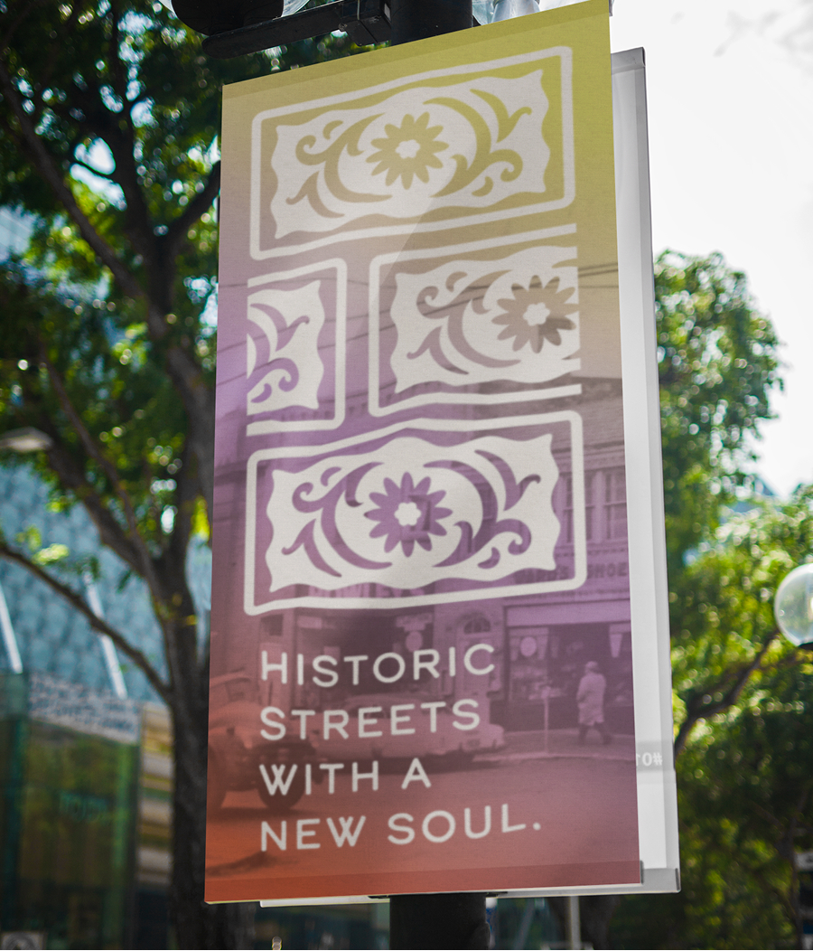 Street banner that reads: "Historic streets with a new soul" with a brick-like pattern created from the logo's icon.