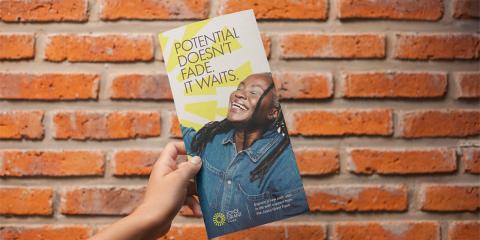 Rack card of woman smiling with text "Potential doesn't fade, it waits."