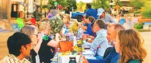 People seated at a long table in downtown Lansing